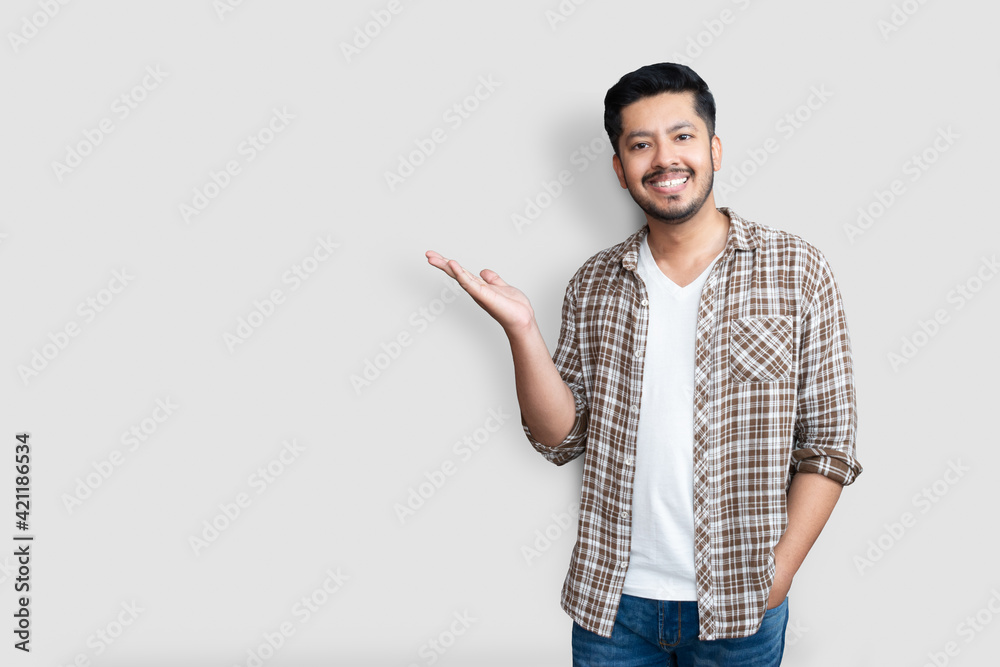 Wall mural adult asian man over isolated background smiling cheerful presenting and pointing with palm of hand 