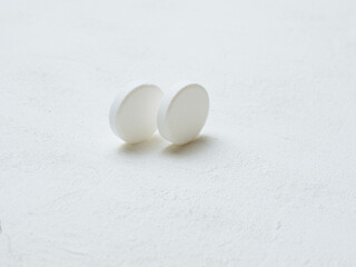 Pill of aspirin on white background.