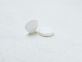 Pill of aspirin on white background.