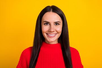 Photo of young positive smiling woman showing white teeth after stomatology procedure isolated on yellow color background