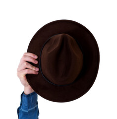Man's arm raised holding a brown hat. Travel concept. Isolate on white background.