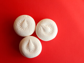 White natural marshmallow on a red background. A healthy dessert. Banner.