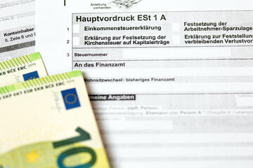German tax form Hauptvordruck ESt 1 A with pen and euro bills
