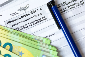 German tax form Hauptvordruck ESt 1 A with pen and euro bills