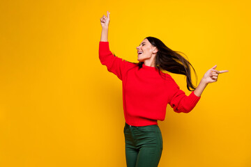 Photo of young beautiful charming smiling crazy woman with closed eyes dancing isolated on yellow color background