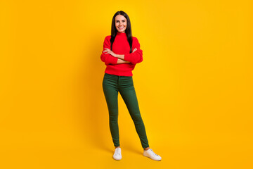 Fototapeta na wymiar Full size photo of young beautiful smiling cool confident woman with folded hands isolated on yellow color background