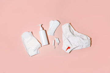 White cotton panties for women with traces of fresh red blood and care products. Concept of menstruation, female shame, taboo, daily hygiene, critical days, premenstrual syndrome