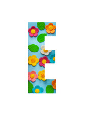 The letters E of the English alphabet is cut out of flowers on a blue  background.Floral pattern, texture for stores,sales,websites,postcards and holiday greetings.