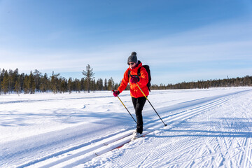 Woman cross country skiing in Lapland Finland