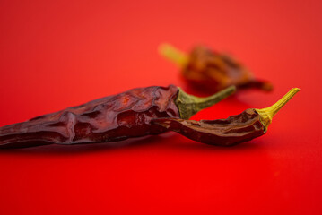 Macro image of dried red chilli pepper on red