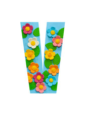 The letters V of the English alphabet is cut out of flowers on a blue  background.Floral pattern, texture for stores,sales,websites,postcards and holiday greetings.