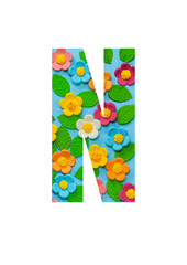 The letters N of the English alphabet is cut out of flowers on a blue  background.Floral pattern, texture for stores,sales,websites,postcards and holiday greetings.