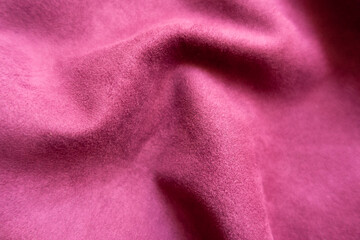 Fototapeta na wymiar Cerise colored faux suede fabric in soft folds