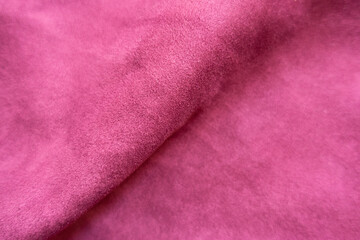 Diagonal soft fold on cerise colored faux suede fabric