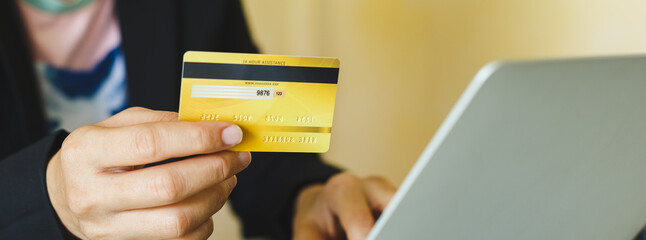 Credit card to pay, woman holding to payment and shopping online with laptop, Substitute for using cash. electronic debit paying. crop image banner soze.