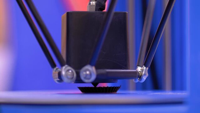 Process of printing physical flat plastic model on automatic 3d printer machine - close up. Additive technologies, 4.0 industrial revolution, 3D printing and prototyping industry concept