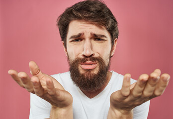 Man with a beard on a pink background sad face emotions model