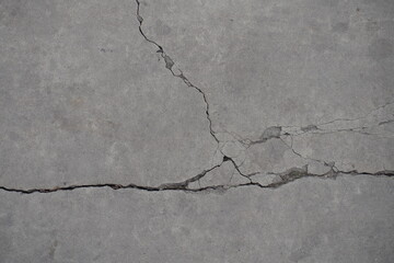 Gray concrete slab with cracks from above