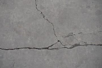 Gray concrete slab with cracks from above
