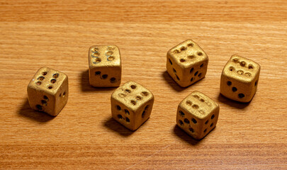 A set of six gambling dice on the table. The dice rolled shows sixes.