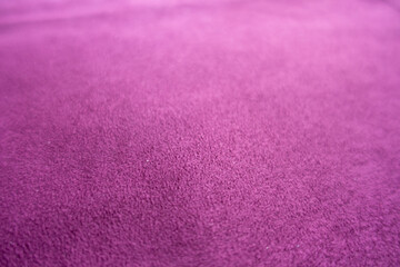 Closeup of magenta colored faux suede fabric