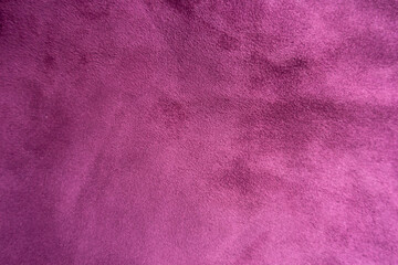 Velvety surface of magenta colored faux suede fabric from above