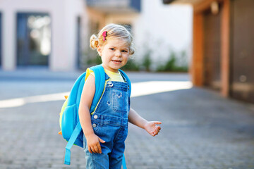 Cute little adorable toddler girl on her first day going to playschool. Healthy beautiful baby...