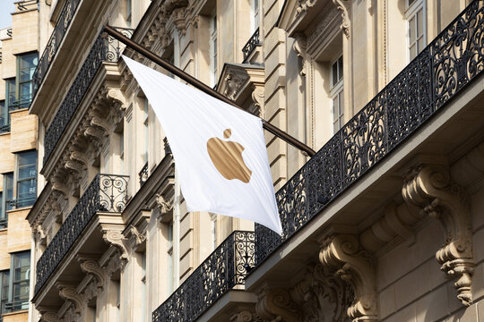 PARIS, FRANCE - OCTOBER 4, 2019: Apple flag on Apple store building at famous luxury Avenue des Champs-Elysees.  Apple Inc. is one of Big Four tech companies along with Amazon, Google, and Facebook.
