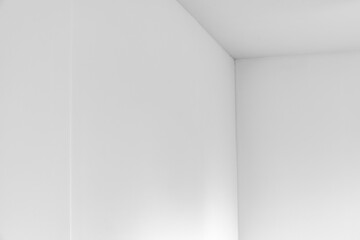 Fototapeta premium detail of plastered house wall still drying with shadow