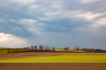 rural landscape with plowed field and dark clouds in the Wetterau