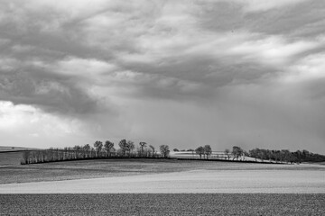 rural landscape with plowed field and dark clouds in the Wetterau