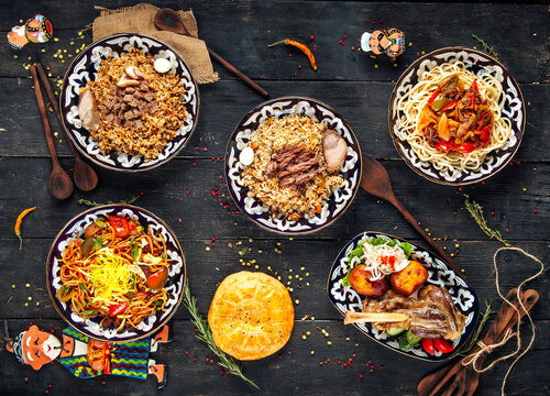 Top view on uzbek oriental cuisine dishes on the wooden background