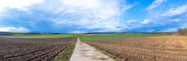 rural landscape with plowed field and dark clouds in the Wetterau