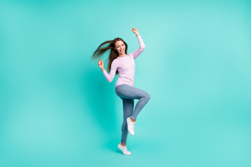 Fototapeta premium Full length body size view of lovely cheerful girl jumping dancing rejoicing isolated over turquoise bright color background