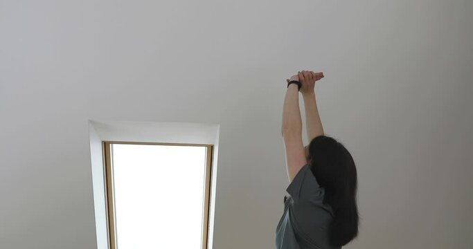 Working from home and exercise at home office. Beautiful woman stretching her back while sitting at workplace. Healthy living and body care.