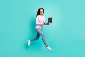 Full length body size view of lovely cheerful girl jumping going using laptop web project isolated...