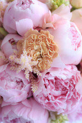 Floral arrangement of fresh pink peonies, astilba, rose and carnation. Content for invitation or postcard. Floral background