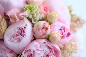 Floral arrangement of fresh pink peonies, astilba, rose and carnation. Content for invitation or postcard. Floral background