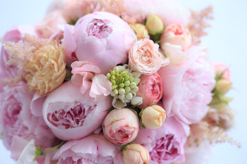 Obraz na płótnie Canvas Floral arrangement of fresh pink peonies, astilba, rose and carnation. The bride's bouquet. Florist work