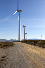 Clean electricity producing wind turbines built on a windy mountain ridge