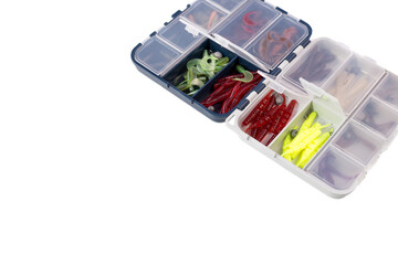 Transparent box with silicone fishing lures isolated on white background