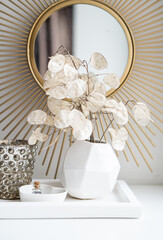 Beautiful white home interior decoration with vases and mirror