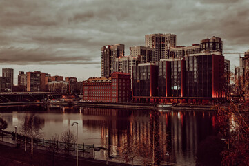 Fototapeta na wymiar Reflection in the water of a massive building, Yekaterinburg, Russia, shot on a cloudy day.