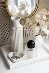 Beautiful white home interior decoration with vases and mirror