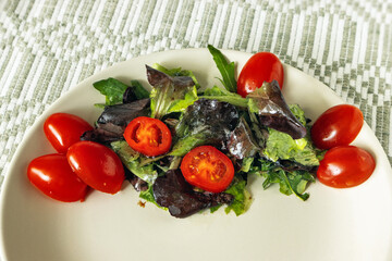 Plum tomatoes with lettuce leaves