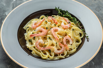 tagliatelle pasta with prawns, bechamel sauce and thyme. Italian pasta fettuccine. Italian food, top view