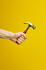 hammer with rubberized handle in cropped male hands