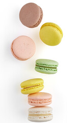 Vertical photo of Macaroon. Colorful cake macaron with pastel tones fall at the stack macaroon on white background. Top view of almond cookies.