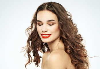 Naklejka premium Pretty woman model with curly hair close-up cropped view