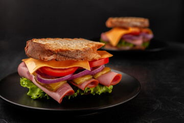 Sandwich with ham, tomatoes, lettuce and yellow cheese